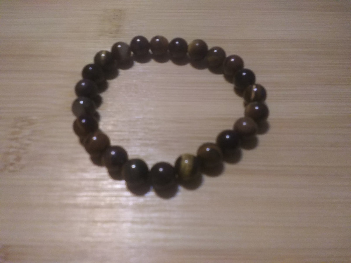 Brown and black bracelet on a wood background