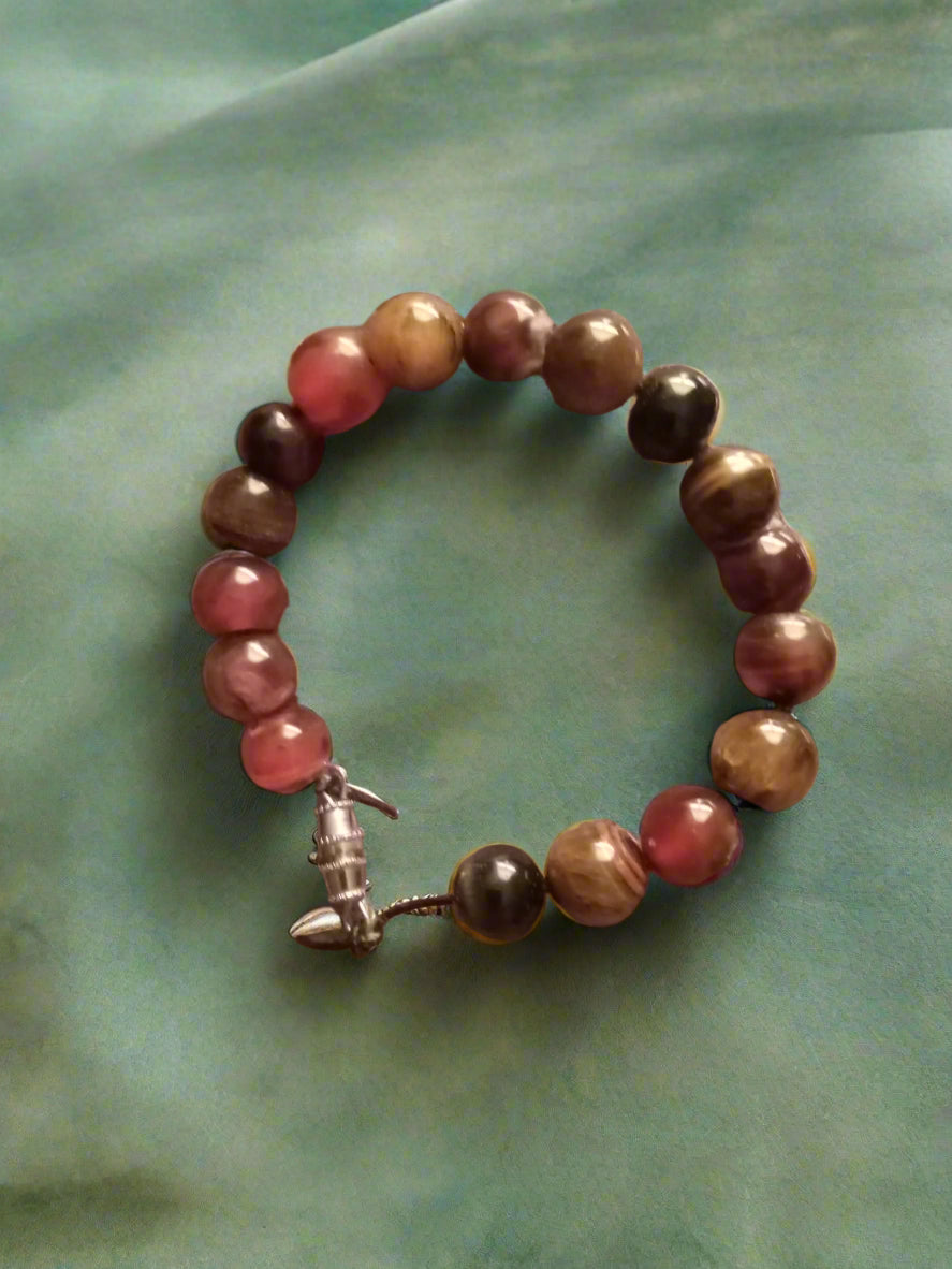 An 8-inch men’s bracelet featuring genuine agate and tiger eye stones, strung on a nylon cord with a twist clasp. A bold and timeless accessory for everyday wear.