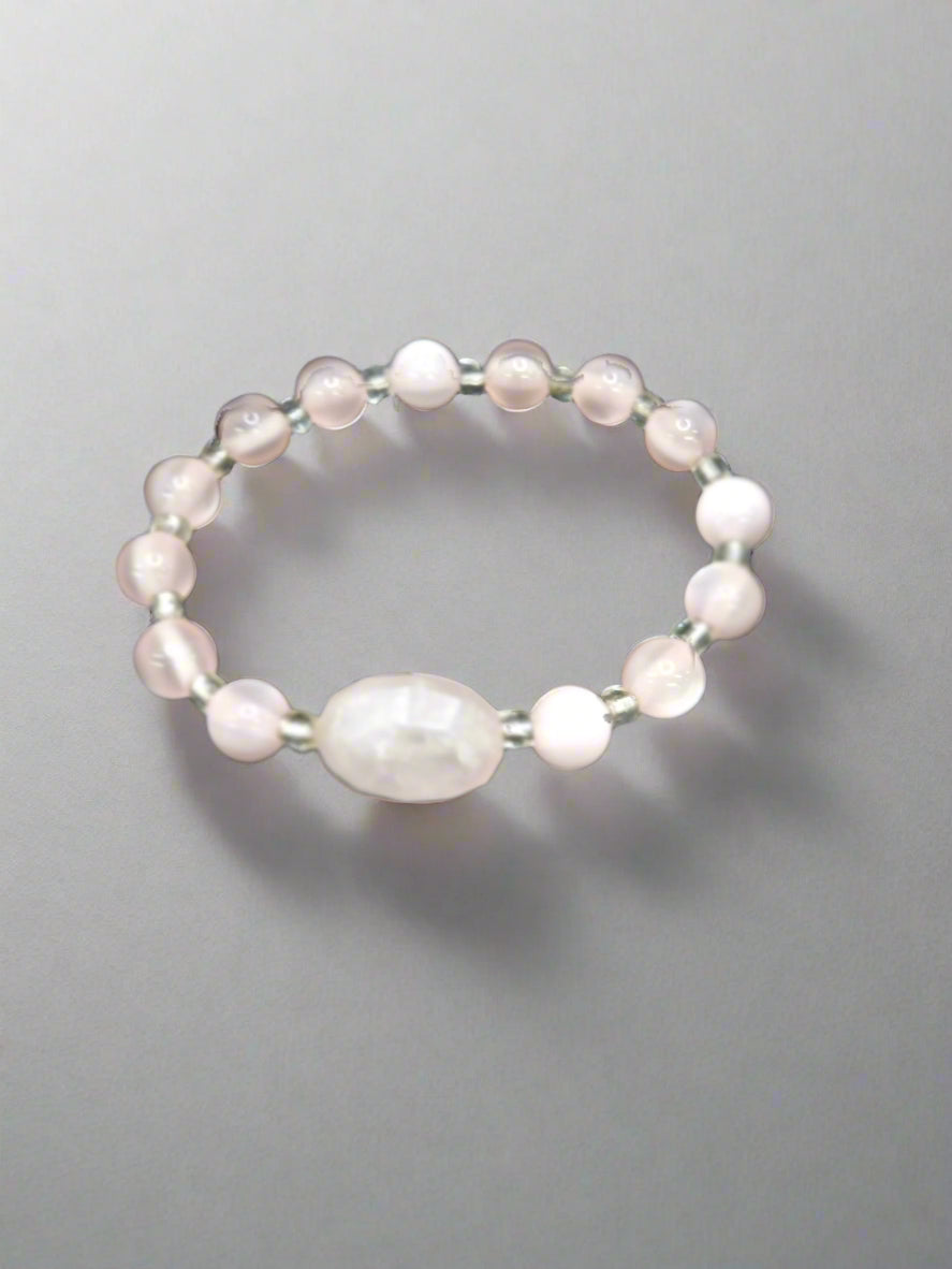 A 6-inch stretch bracelet featuring 6mm natural rose quartz beads with a cat’s eye focal bead. A soft pink, elegant piece symbolizing love, healing, and strength.