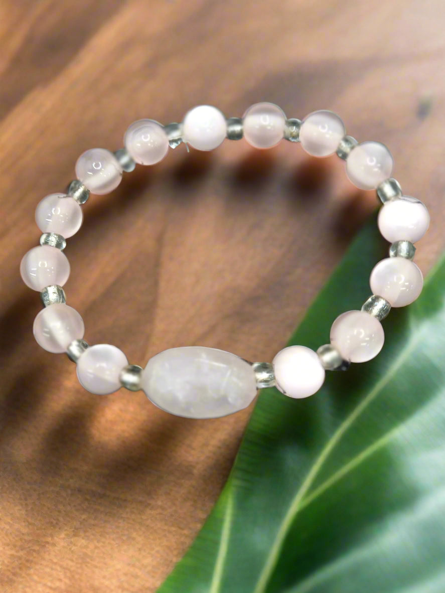A 6-inch stretch bracelet featuring 6mm natural rose quartz beads with a cat’s eye focal bead. A soft pink, elegant piece symbolizing love, healing, and strength.