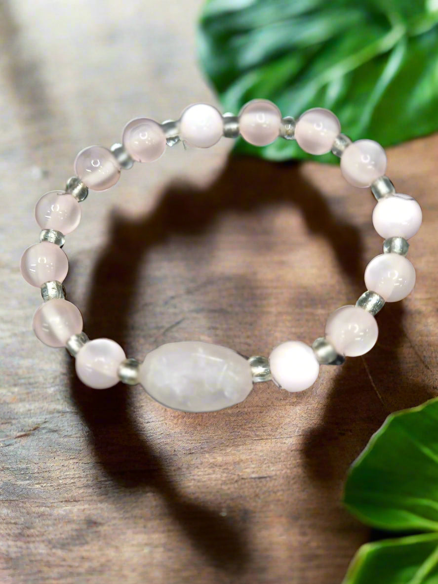 A 6-inch stretch bracelet featuring 6mm natural rose quartz beads with a cat’s eye focal bead. A soft pink, elegant piece symbolizing love, healing, and strength.