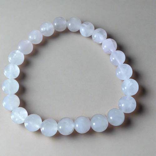Close-up of a handcrafted women's rose quartz bracelet with soft pink beads, symbolizing love and harmony.