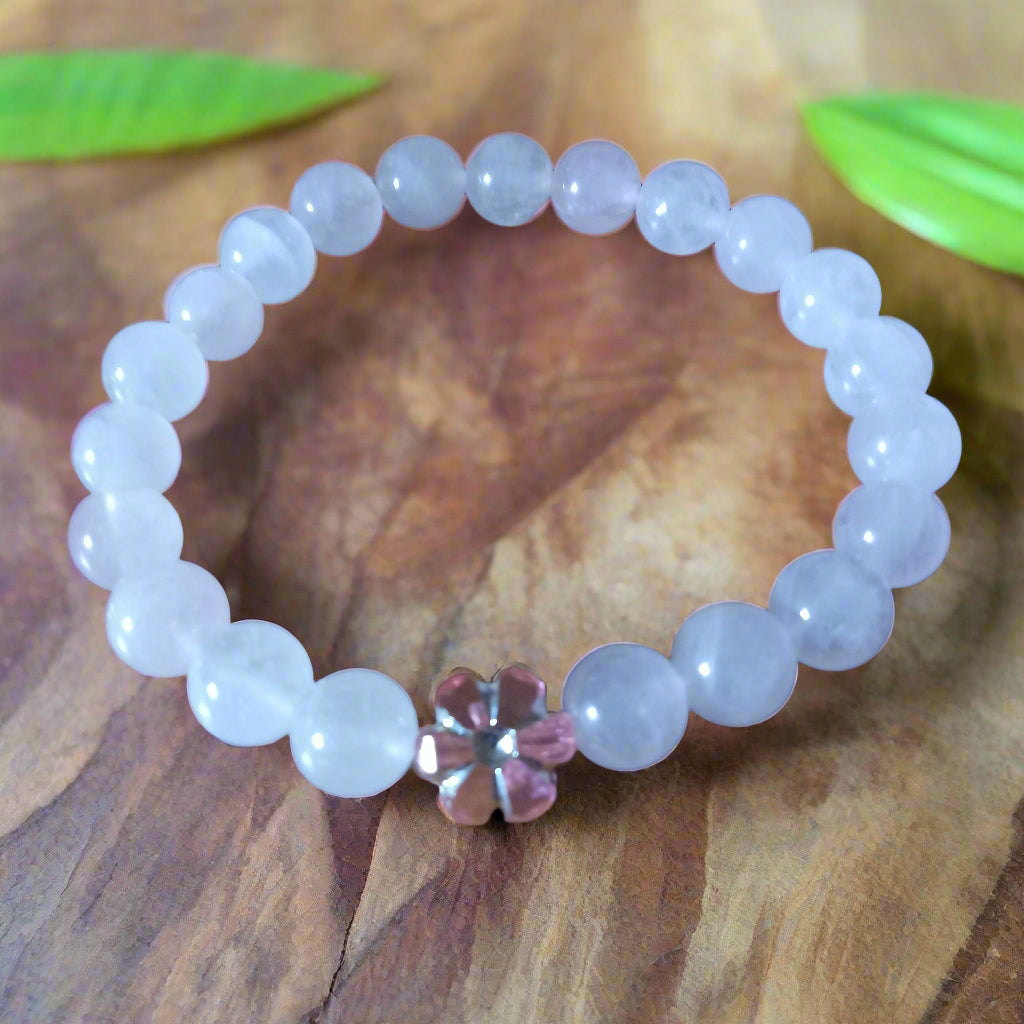 floral rose quartz bracelet with soft pink beads and a delicate flower charm, symbolizing love and harmony.