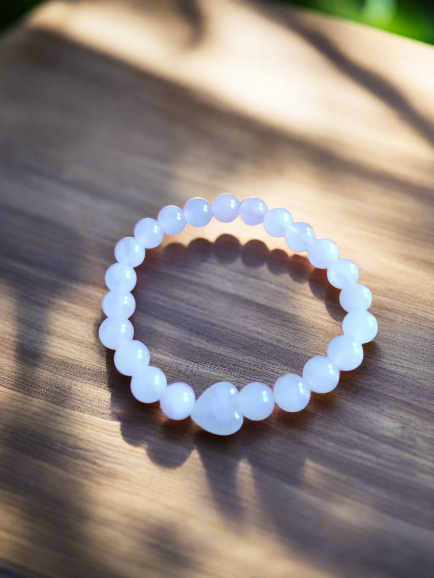 Pink beaded bracelet on a wooden surface