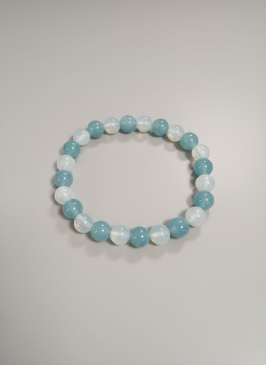Light blue beaded bracelet on a light background.