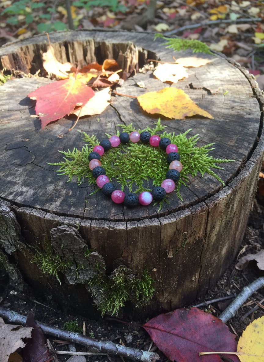 Bracelet with red and black beads on a wooden surface