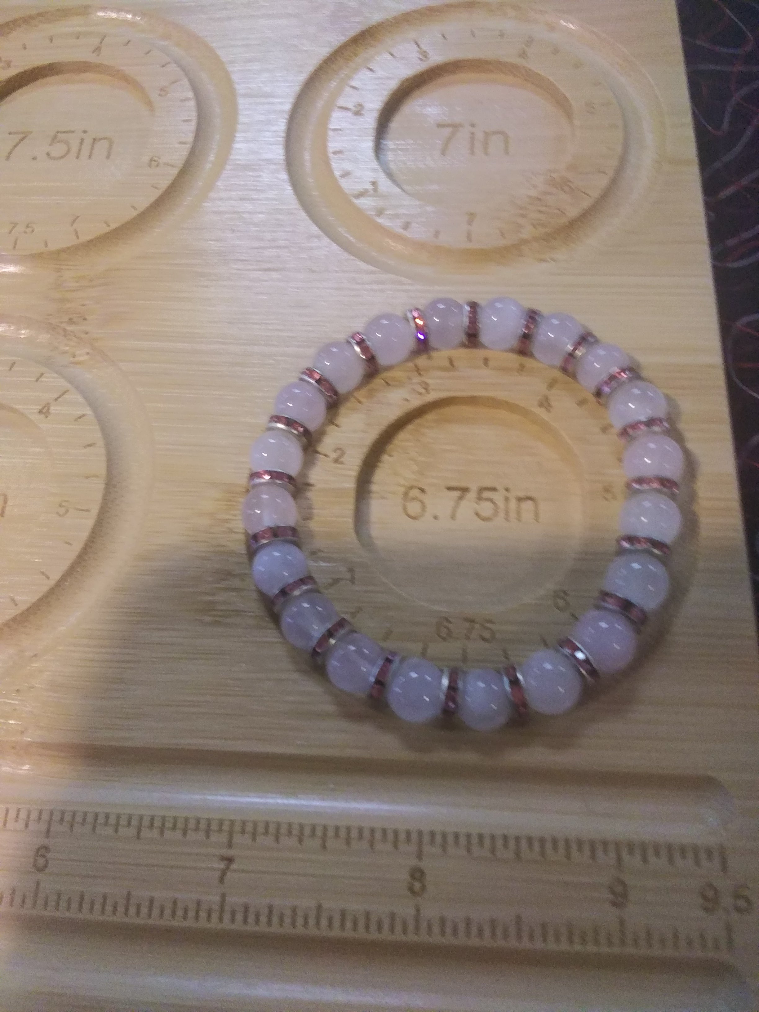 Bracelet on a wooden board with measurement markings