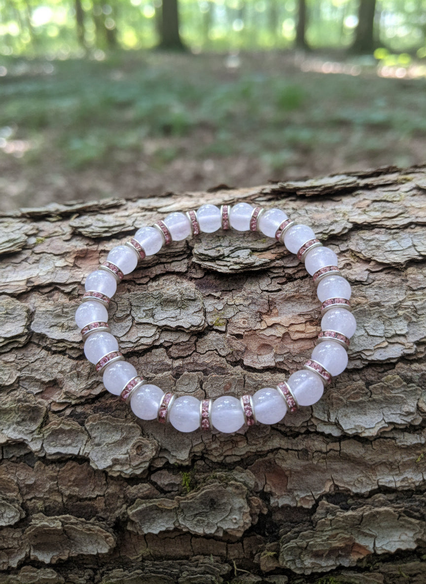 Bracelet with pink beads on a tree surface