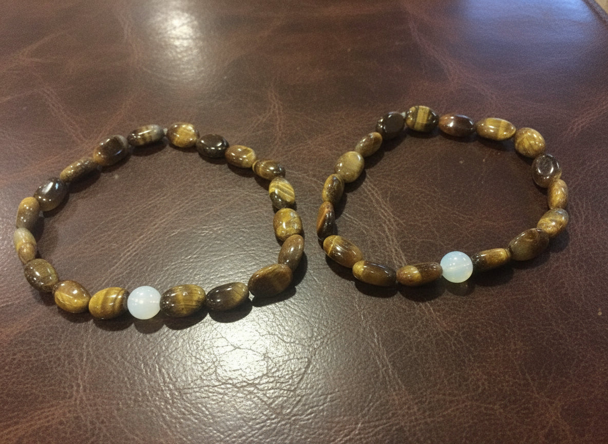 Two brown bracelets with a white stone