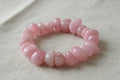 A bracelet made of pink rose quartz nuggets, with a stretchy band to fit around the wrist.