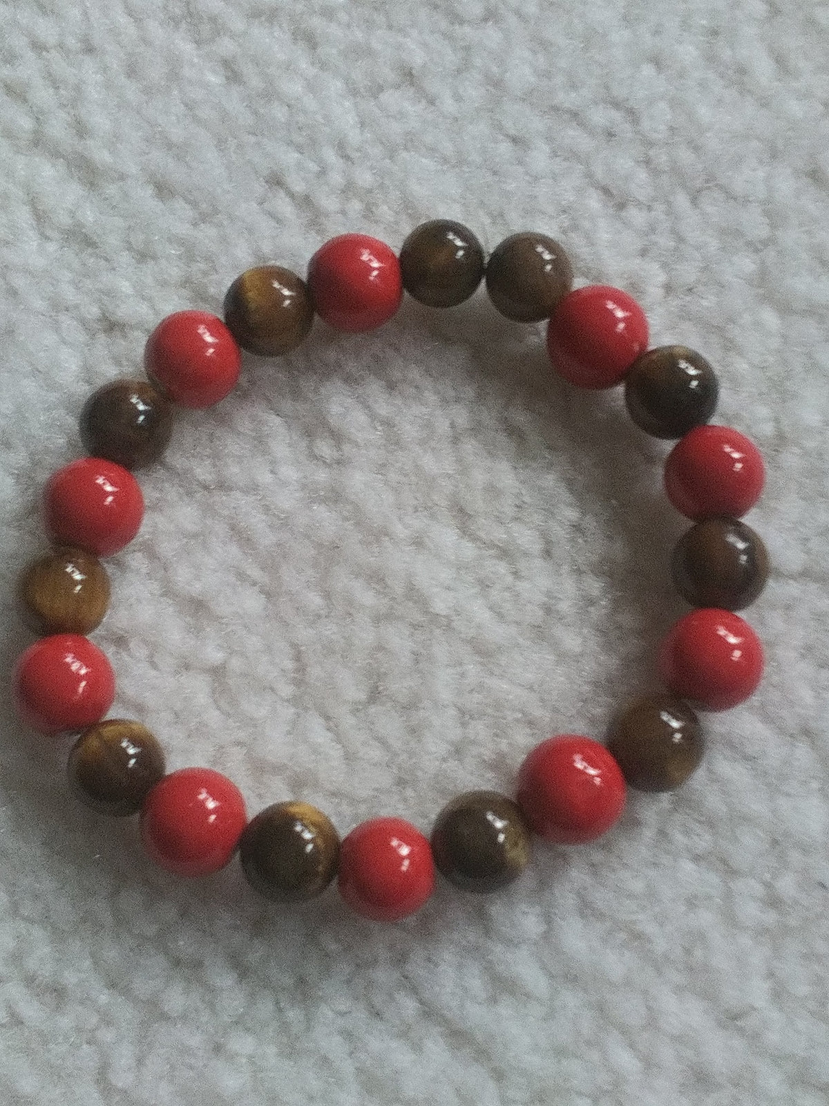 handcrafted 8-inch men's stretch bracelet featuring polished tiger eye beads for focus and confidence, paired with rich red jasper stones for grounding and protection, creating a bold yet sophisticated look.