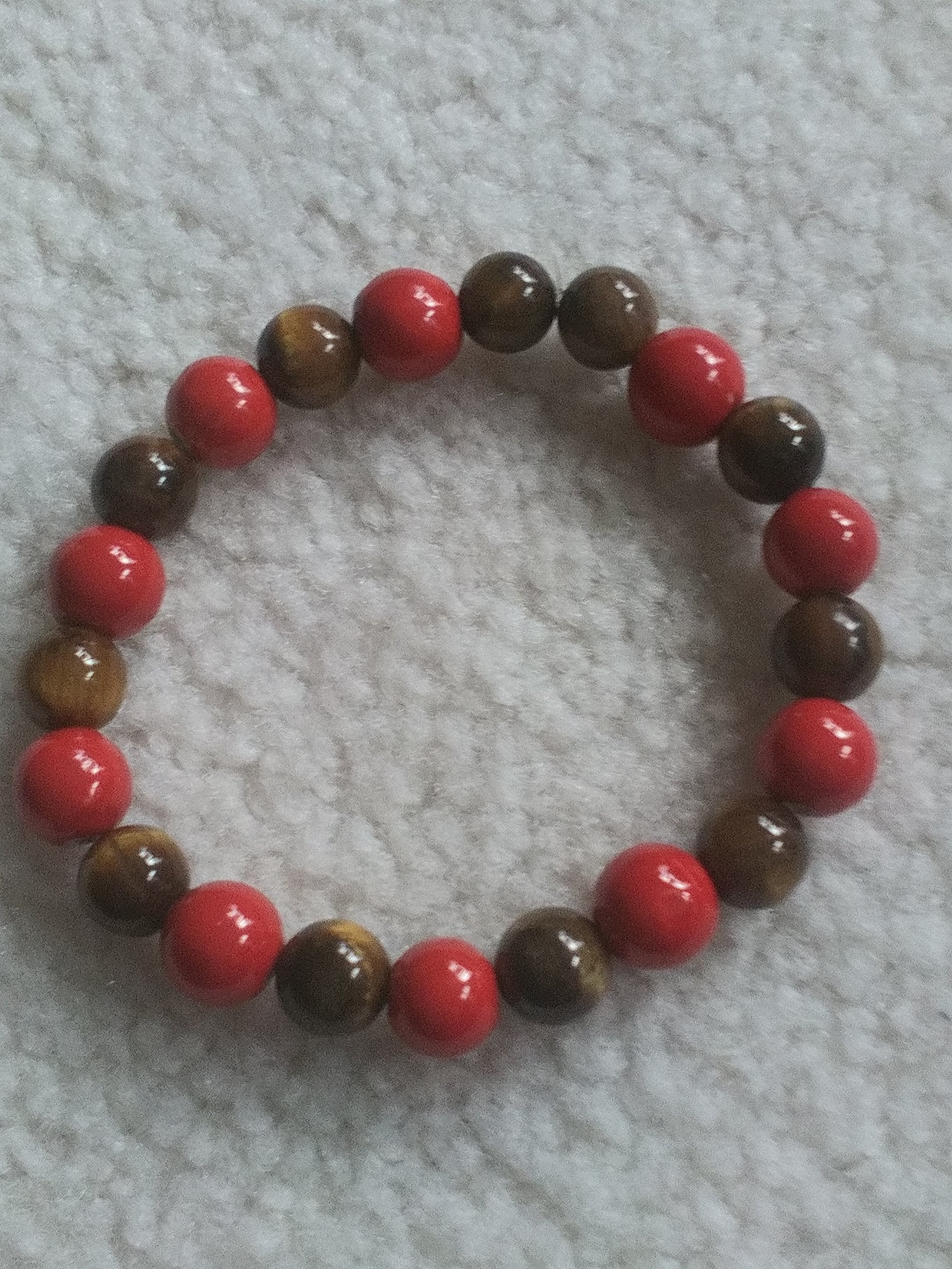 handcrafted 8-inch men's stretch bracelet featuring polished tiger eye beads for focus and confidence, paired with rich red jasper stones for grounding and protection, creating a bold yet sophisticated look.